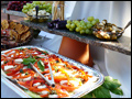 Trays of caprise salad, olives and grapes at a catered backyard wedding