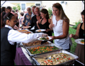 best party caterer on Long Island serving up hot dishes at a tent wedding