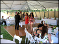 dance floor and dinner tables under white tent