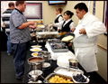 crepe station at a catered corporate breakfast with crepes being cooked right in front of you