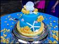 beach themed turquoise wedding cake decorated with sea shells and yellow roses