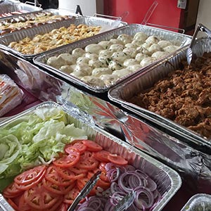bbq food including pulled pork and burger toppings, ready to be served
