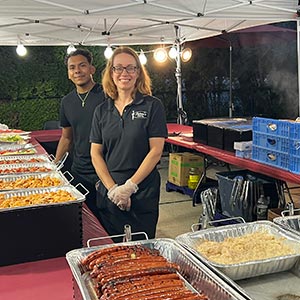 Felicos staff serving at an outdoor BBQ