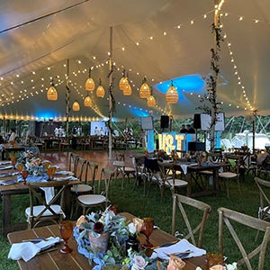 A stunning catered wedding reception showcasing elegantly set tables, and colorful floral arrangements