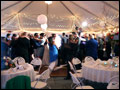 Wedding guests have left their tables to join the bride and groom on the dance floor for the first dance