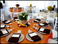 Tables are decorated with mums and pumpkins and set in autumn colors for a catered outdoor wedding in New York