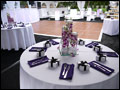 Long Island catered wedding table setup with orchids, purple and white linens and lounge decor