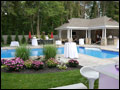 Backyard wedding setup on Long Island with cocktail tables, a bar and a sushi station