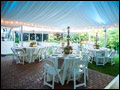beautiful lined party tent at a Tuscan style catered backyard wedding 